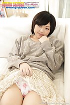 Mei Kadowaki leaning back on couch hand raised to her face cute short hair pulling her short skirt up over her panties