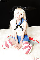 Bunny girl kneeling in skirt wearing striped stockings