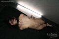 Lying on her side naked small tits shaved pussy